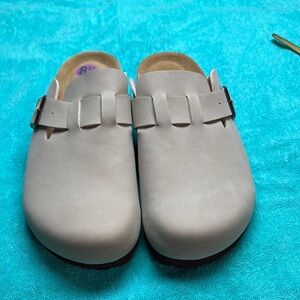 Woman’s tan slip on clogs never worn.